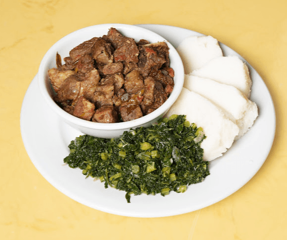 Ugali with fried beef and greens